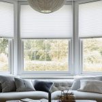 Extra large pleated blinds in white, featuring a 50mm fold, showcased in the window opening. Contemporary top down bottom up privacy shades for apartment